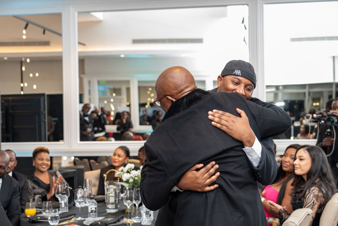 A warm embrace between Mudiwa and a supporter