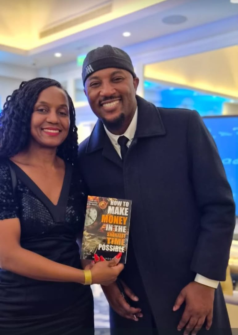A fan posing with a signed copy
